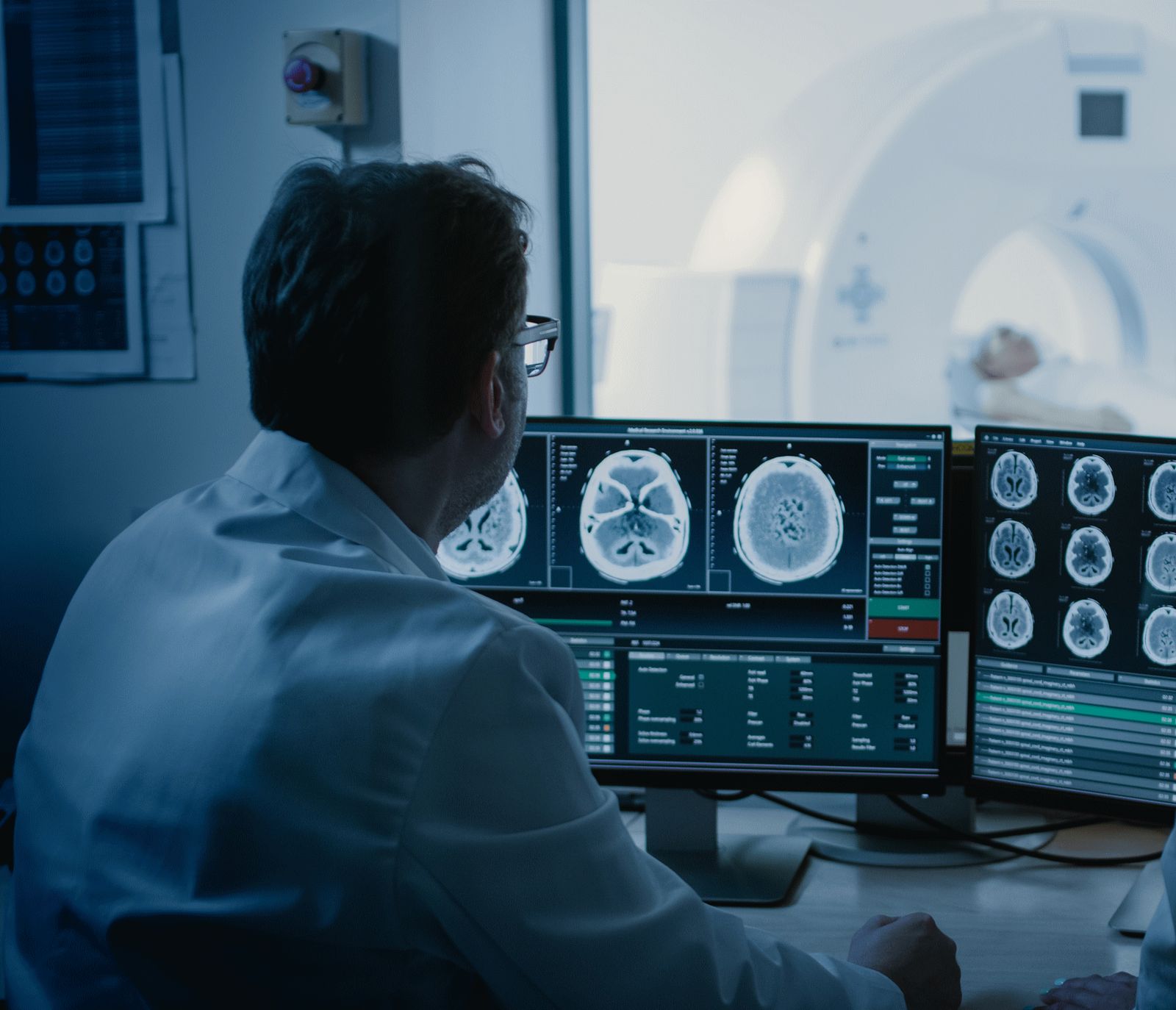 Scientist examining medical imaging dashboards on a laptop computer